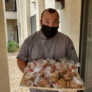 Eric Kirby Executive Chef delivering cookies to senior independent living in Phoenix