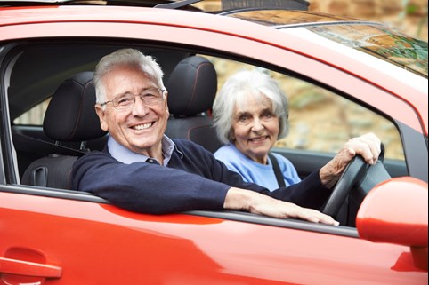 Elderly couple safely driving a vehicle