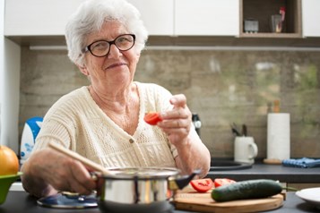 Elderly woman cooking