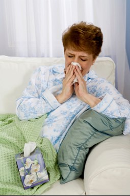 Woman blowing her nose