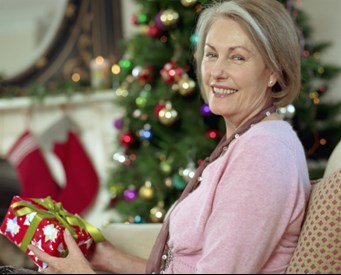 Elderly woman opening a present