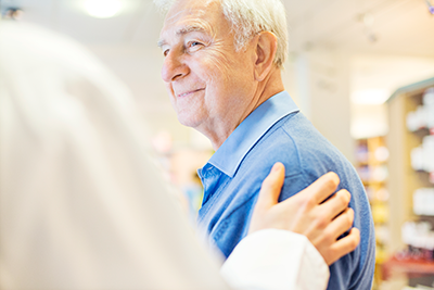 Senior man smiling at another person