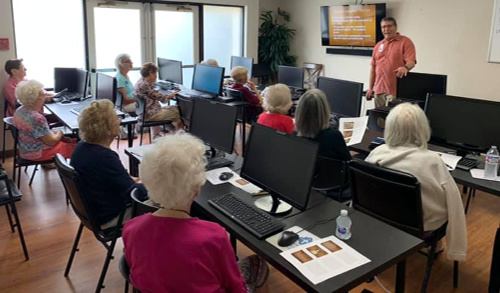 Photo of seniors in computer class, continuing education in senior living