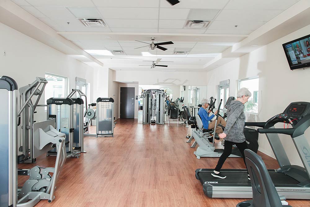 Seniors exercising in fitness center at Fellowship Square