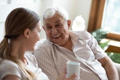 Senior dad with adult daughter, having coffee