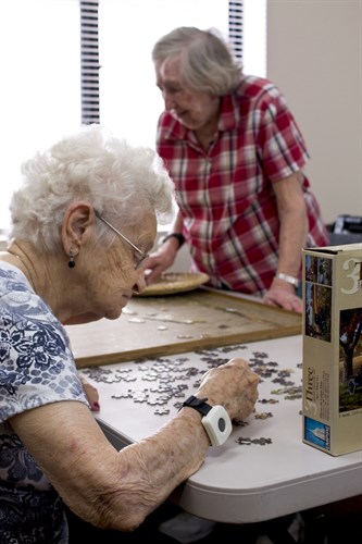 Senior Ladies working puzzles in Assisted Living