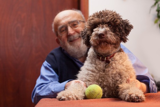 Senior playing with his dog at Fellowship Square Tucson