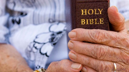 Photo of senior holding the Bible