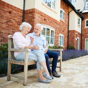 Photo of senior couple enjoying the courtyard at Fellowship Square Surprise