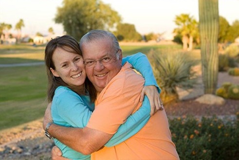 Senior & his granddaughter hugging at Fellowship Square Senior Living AZ