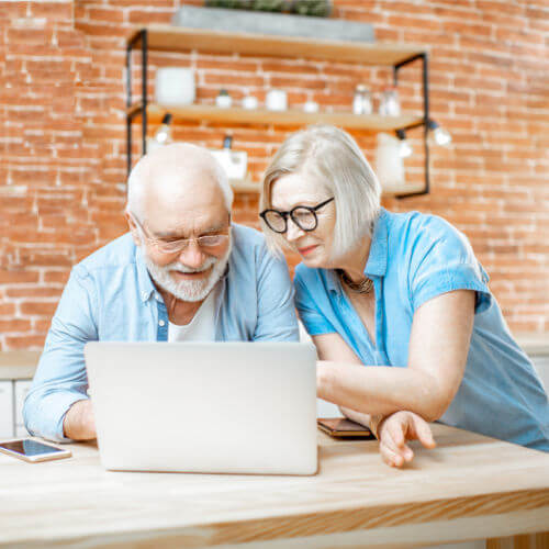 Senior couple calculating cost of Independent Living and Assisted Living in Phoenix