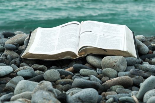Photo of a Bible near the water